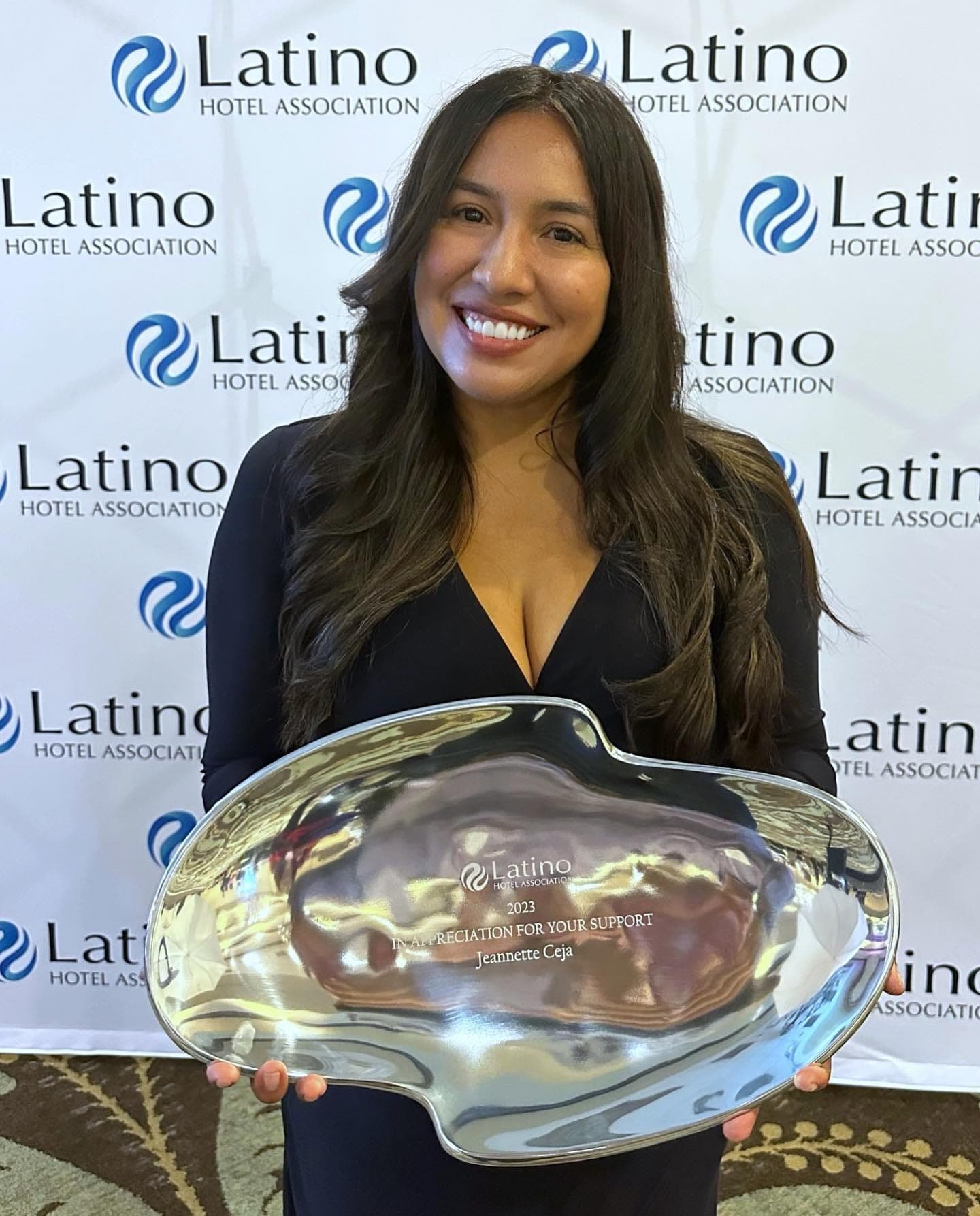 Jeannette Ceja receiving an award from the Latino Hotel Association